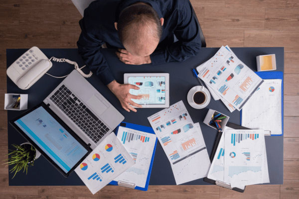 businessman using tablet pc analyzing financial charts and documents